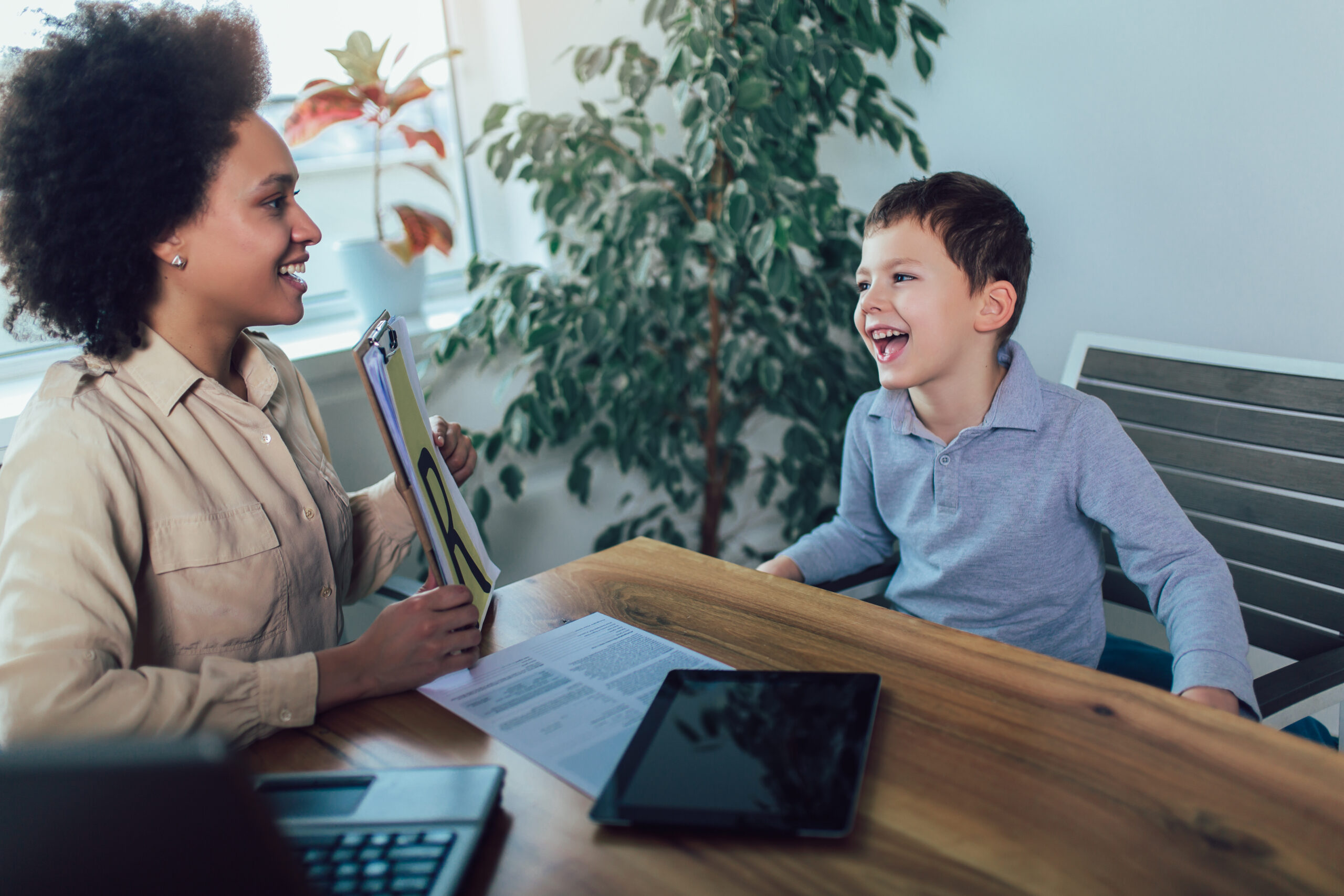 Shot of a speech therapist during a session with a little boy Shot of a speech therapist during a session with a little boy